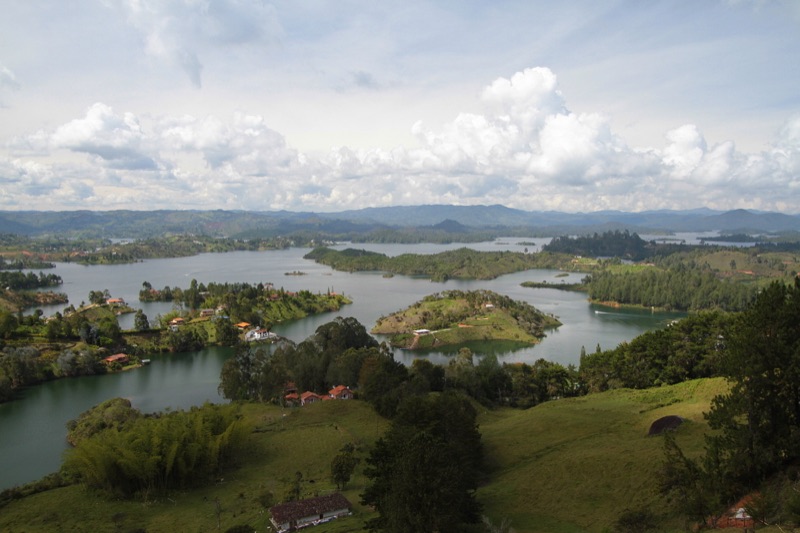 The Peñol-Guatapé reservoir seen from above, with green peninsulas and islands spreading into the distance
